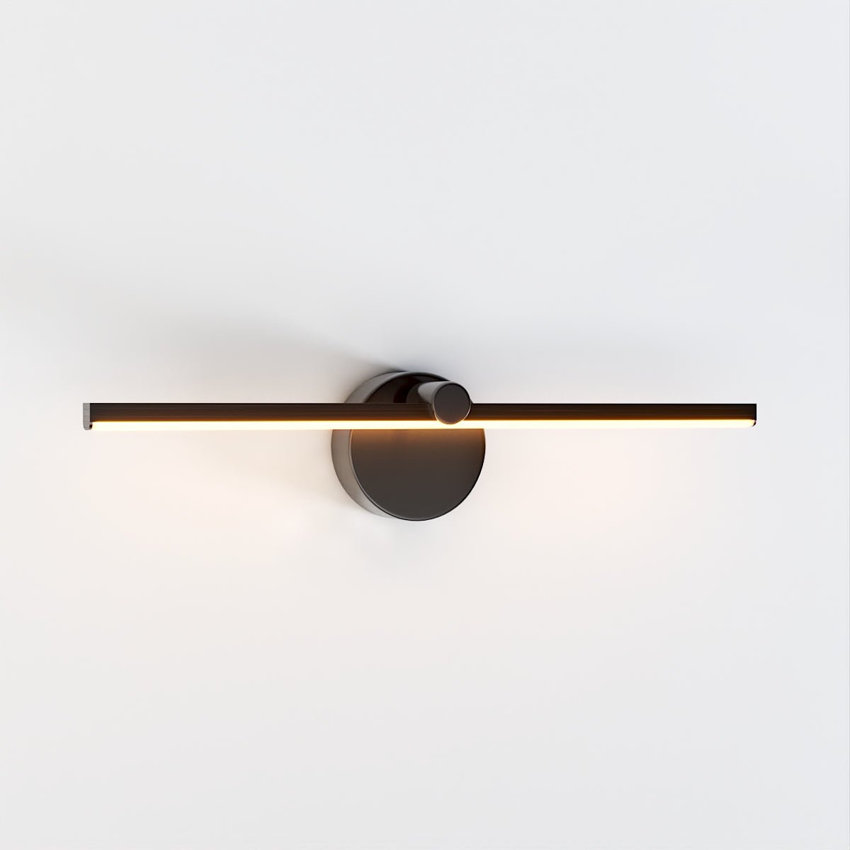Clérachic wall lamp in matte black photographed head-on, its slim bar glowing warm white on a plain background.