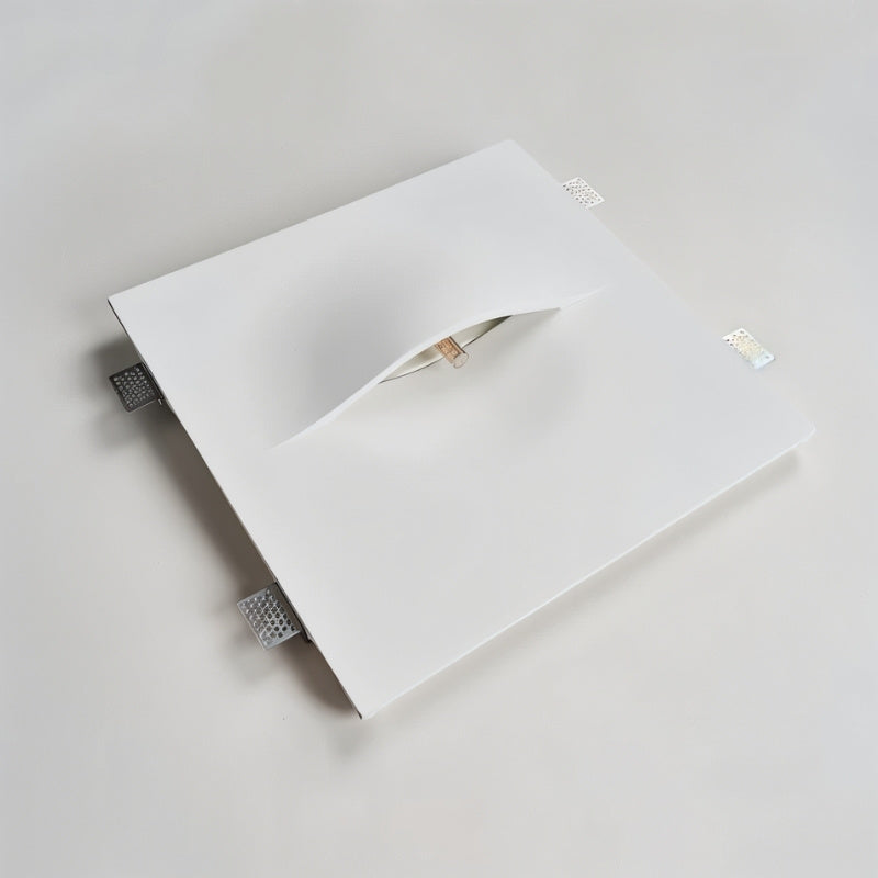 An angled view of the Clérachic trimless wall light's square plaster plate and mounting clips.