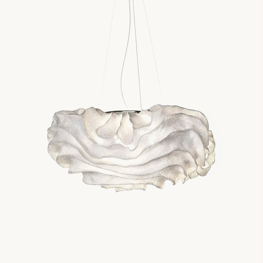 This Clérachic pendant on a plain white backdrop, its white mesh shade folded into soft ruffled layers beneath fine hanging wires.