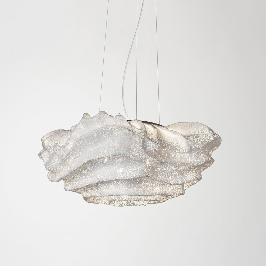 This Clérachic pendant on a pale backdrop, with a white perforated mesh shade hanging from three thin wires.