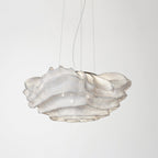 This Clérachic pendant on a pale backdrop, with a white perforated mesh shade hanging from three thin wires.