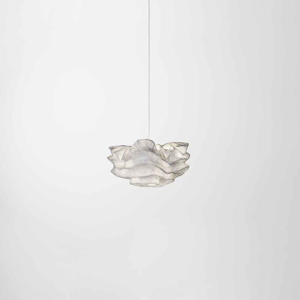 A small Clérachic pendant floating against a soft white backdrop on a single thin cord.