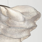 Close view of the perforated mesh on this Clérachic pendant, with a folded ridge catching the light.