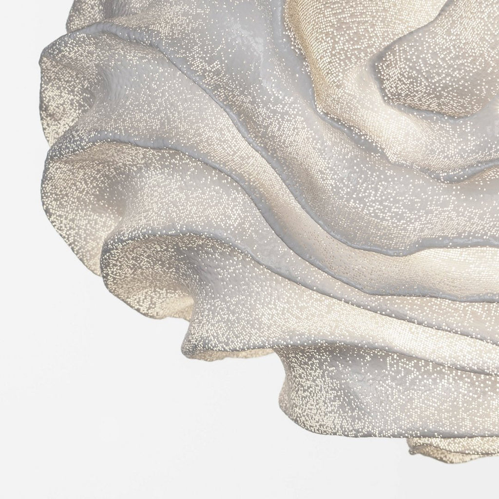 Close view of the flowing, wave-like folds on this Clérachic pendant shade, with pinprick perforations along each layer.