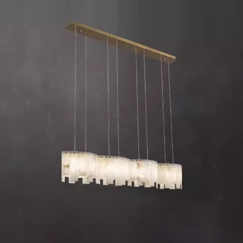 Clérachic Willamette Alabaster Drum Chandelier in its linear form, stone shades strung along a straight brass canopy.