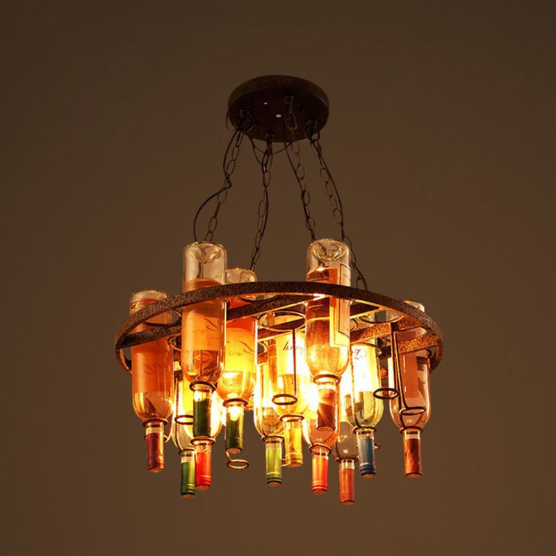 The Clérachic wine bottle chandelier in its large round-frame style, multi-colour glass shades ringing a wide antique metal hoop while lit.