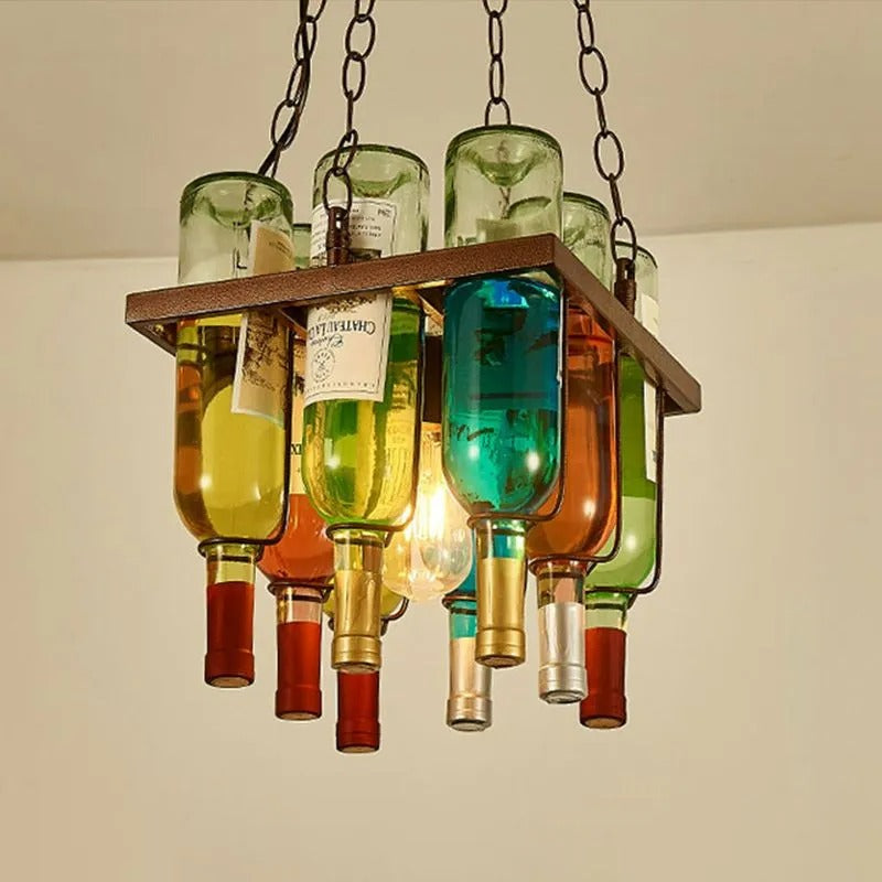 Close-up of the Clérachic wine bottle chandelier's peaked frame, wine labels and a glowing filament bulb visible among the glass necks.