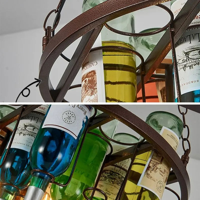Close-up pair showing the Clérachic wine bottle chandelier's hammered metal ring and coloured glass bottles, labels in blue, green, and yellow.