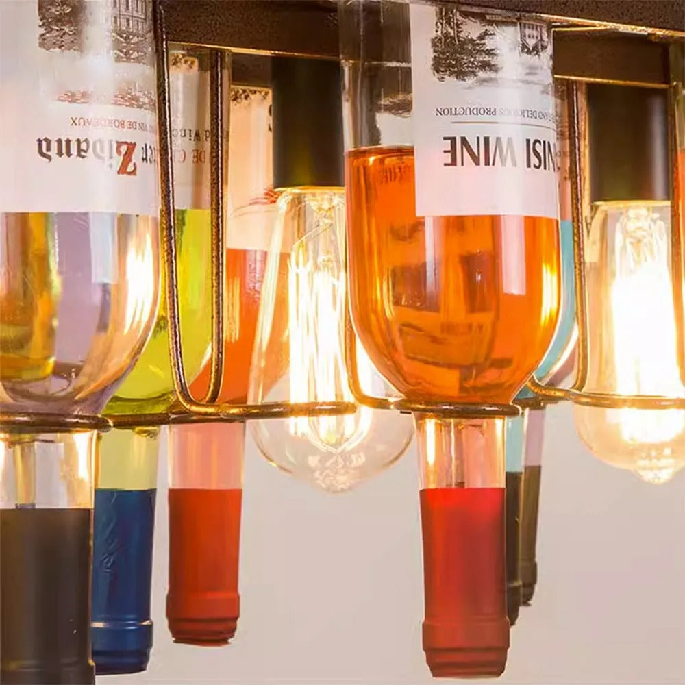 Warm filament bulbs shine through colored bottles on the Clérachic Wine Bottle Glass Pendant Light.