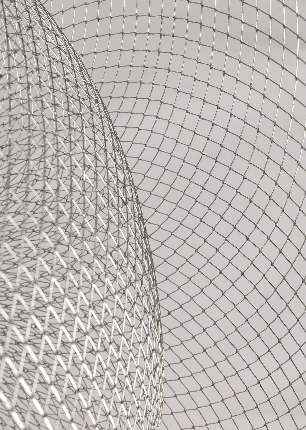 Close view of the fine silver wire mesh on the nested bowls of this Clérachic chandelier.