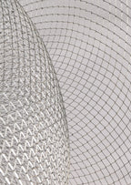 Close view of the criss-cross silver mesh on this Clérachic chandelier, with a curved bowl edge in the foreground.