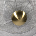 View from below of the brass orb at the centre of this Clérachic chandelier, ringed by the silver wire mesh.