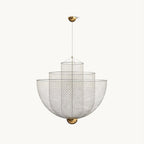 A Clérachic chandelier of stacked silver wire-mesh bowls on a thin cord, with a brass canopy, on a plain off-white backdrop.