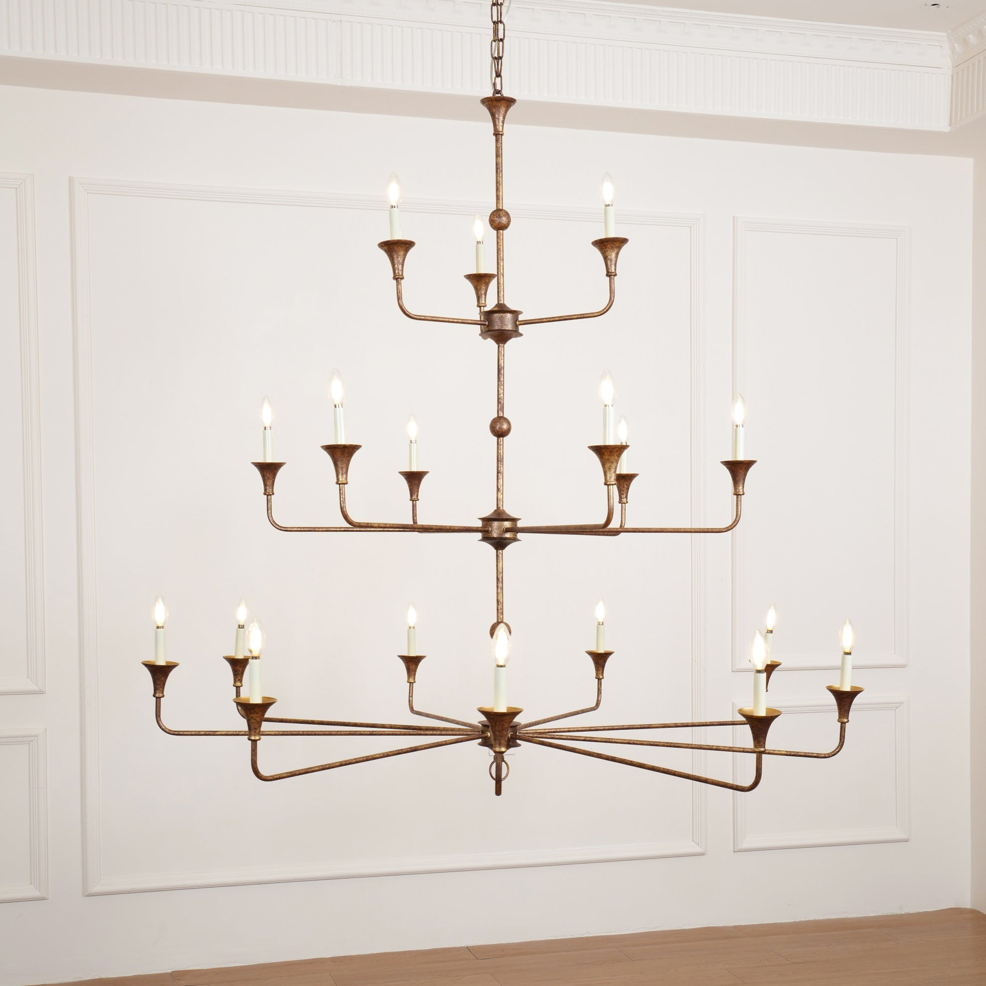 The Clérachic Wisp Grande chandelier's smaller nine-arm version hangs lit in the same wainscoted room.