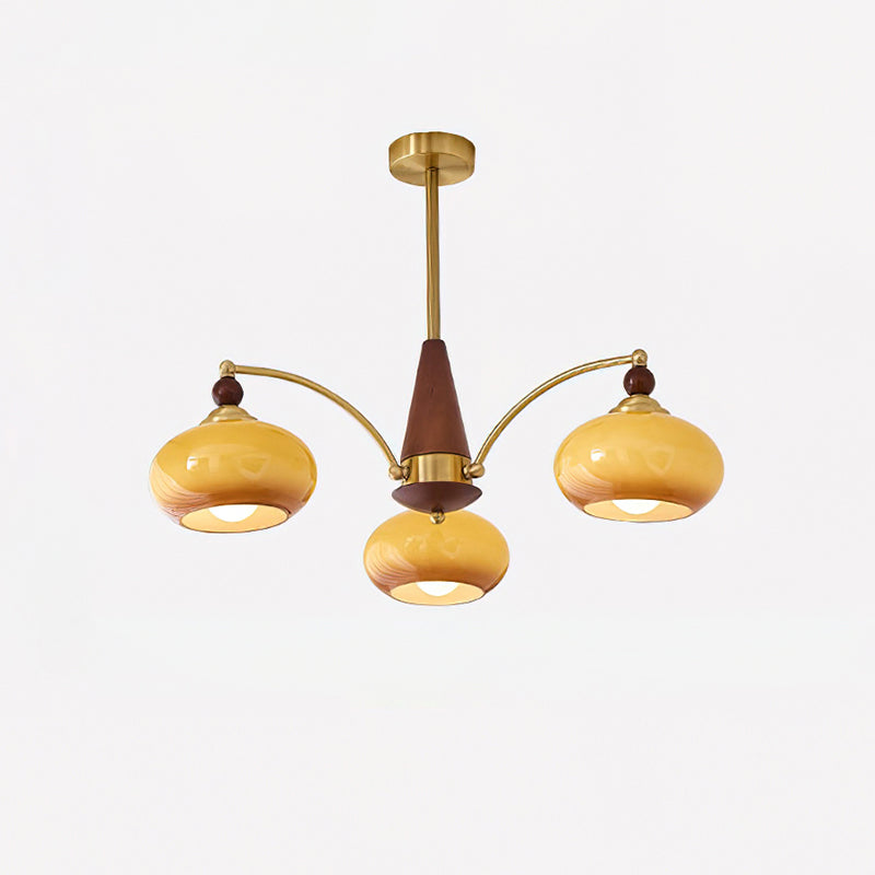 Clérachic Wood and Brass Chandelier in caramel glass, three lit shades on curved arms below a turned wood cone.