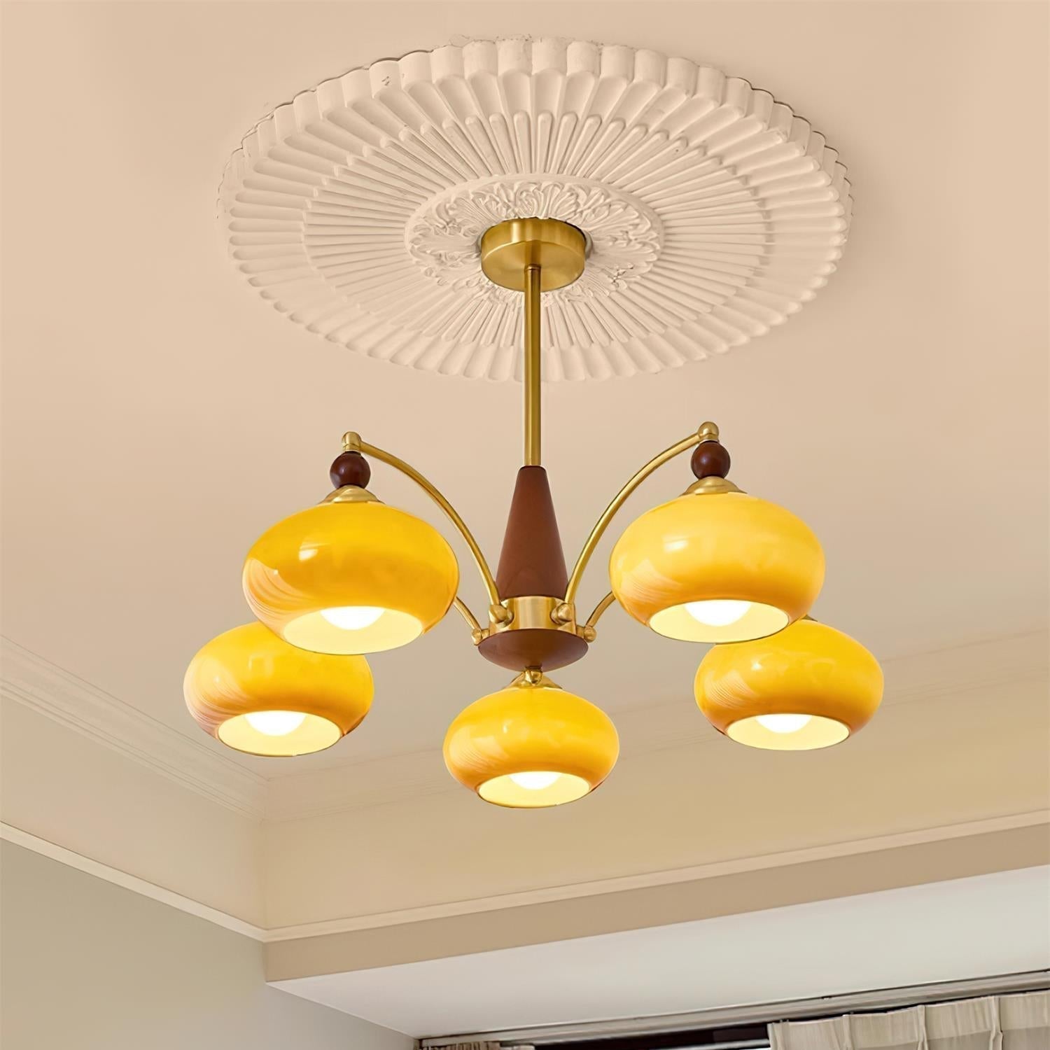 Clérachic Wood and Brass Chandelier in caramel, five shades glowing beneath a moulded plaster ceiling rose.