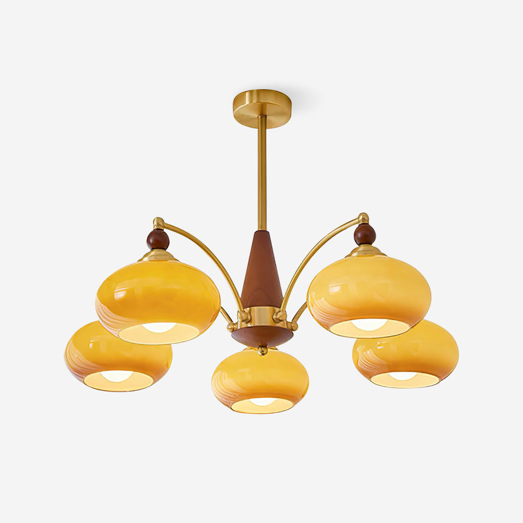Clérachic Wood and Brass Chandelier in caramel glass, five lit shades against a soft grey studio backdrop.