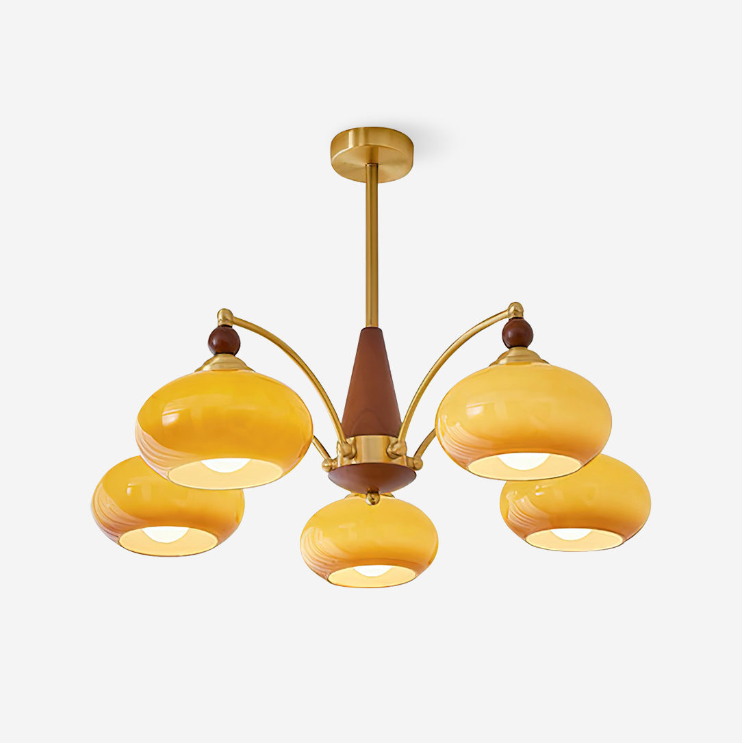 Clérachic Wood and Brass Chandelier in caramel glass, five lit shades against a soft grey studio backdrop.