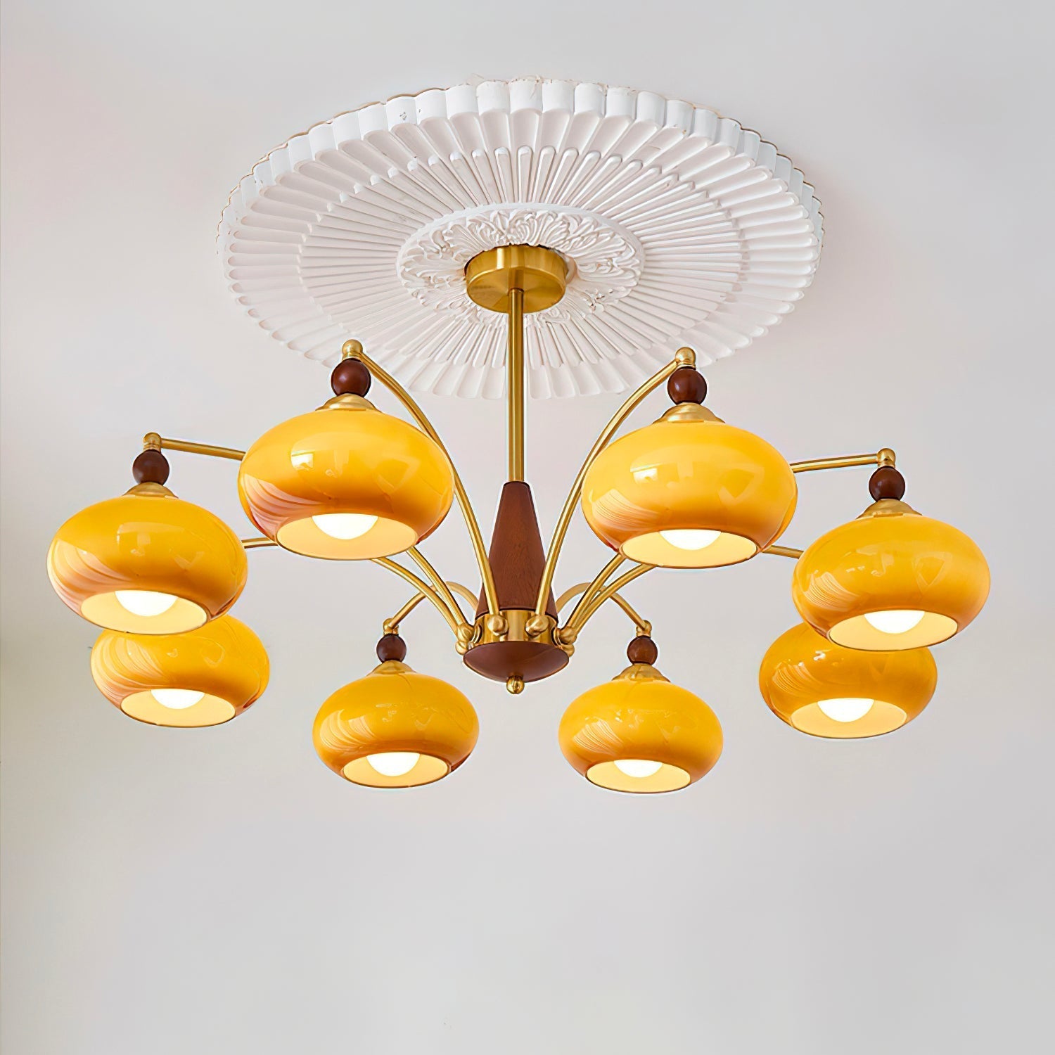 Clérachic Wood and Brass Chandelier in caramel lighting a room from beneath a fluted ceiling medallion.