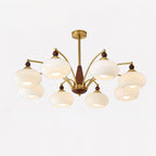 Clérachic eight-light Wood and Brass Chandelier in ivory glass, arms spread wide across a studio frame.