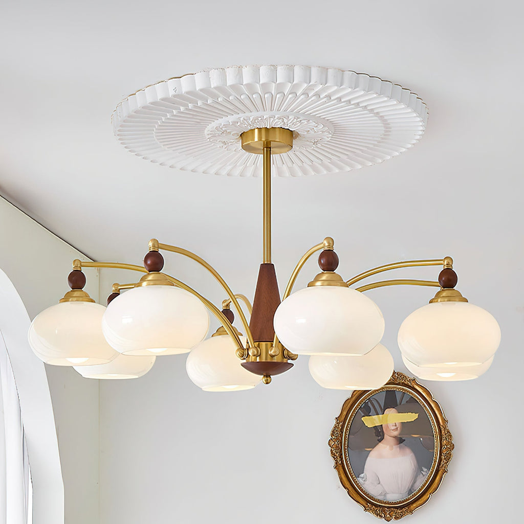 Clérachic eight-light Wood and Brass Chandelier in white glass, lit beside an arched window and gilt frame.