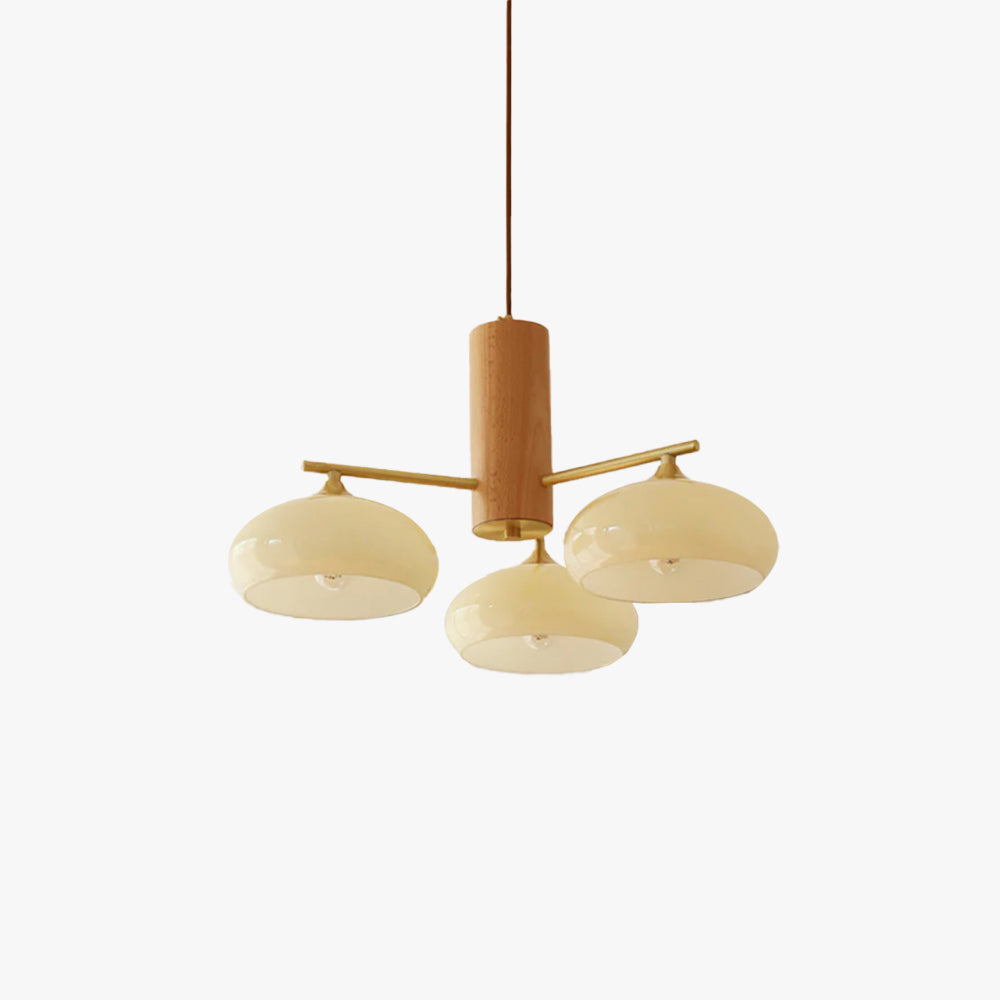 Studio view of the three-light Clérachic chandelier, beige glass discs on brass rods through a turned wood cylinder.