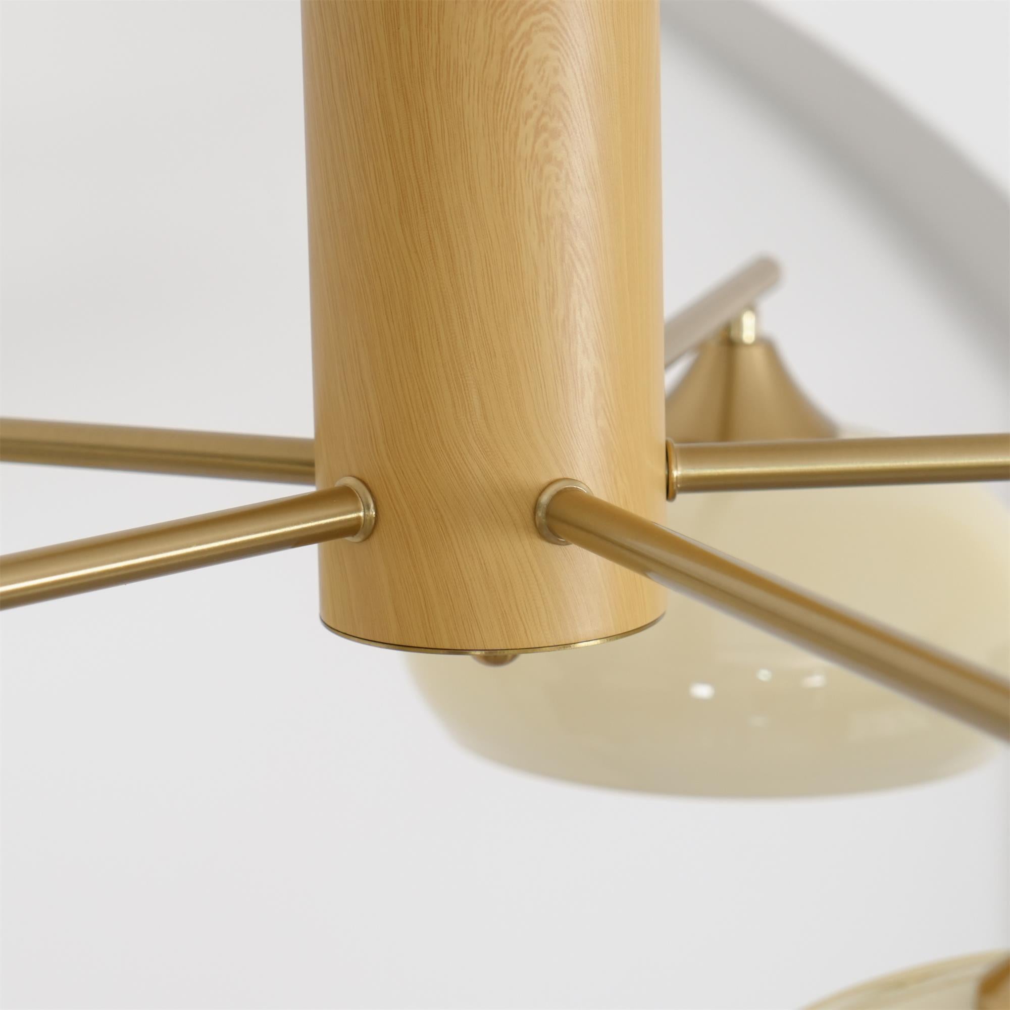 Macro of the Clérachic chandelier's wood grain body where the brushed brass rods pass cleanly through it.
