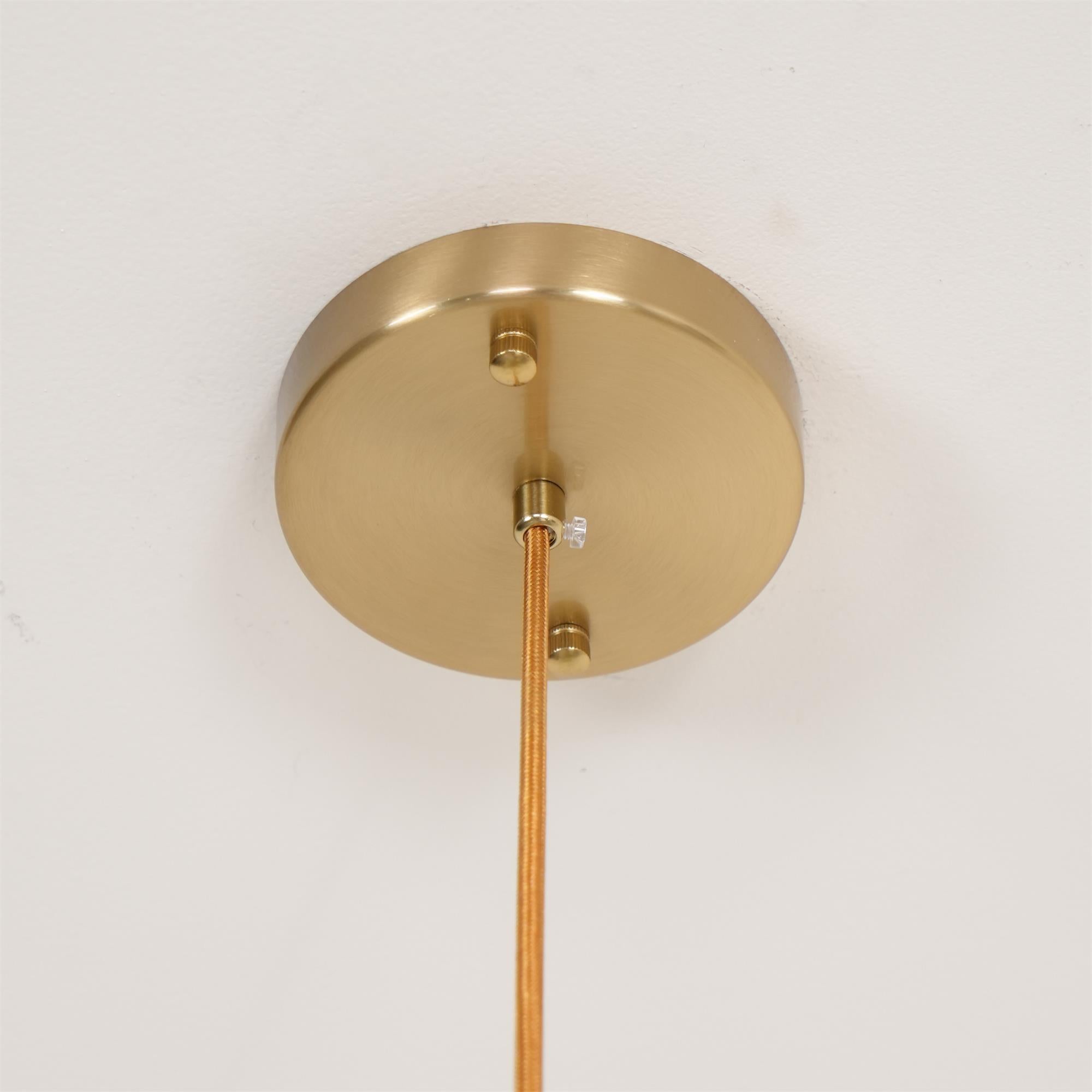 Brass ceiling canopy of the Clérachic chandelier fixed to the ceiling, braided cord held by two knurled screws.