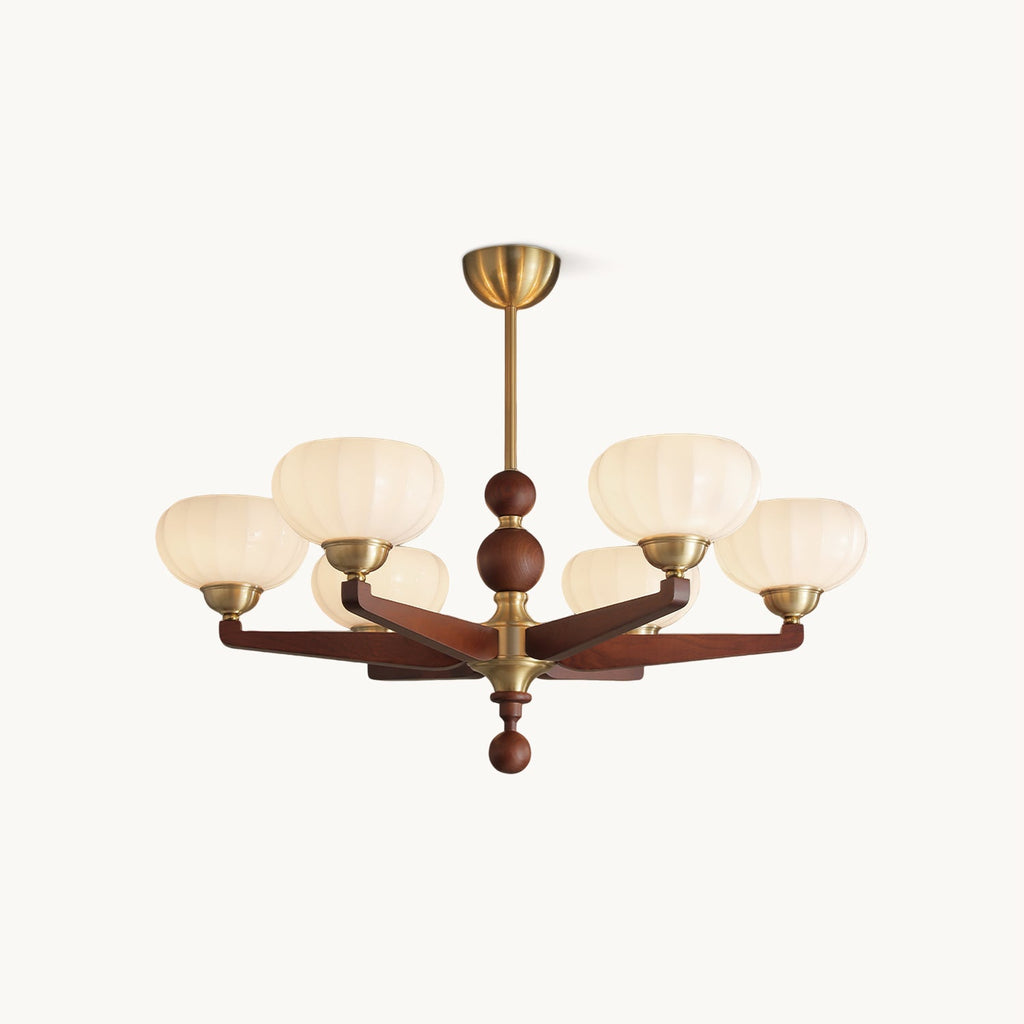 A Clérachic chandelier with cream glass shades on turned wood arms and brass fittings, shown on a plain white backdrop.
