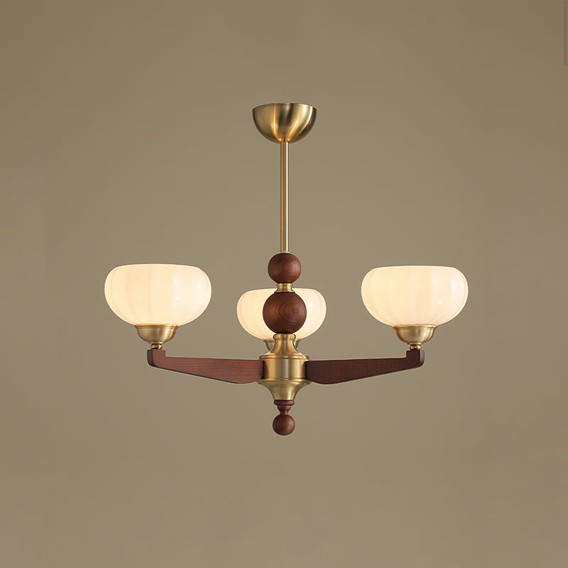 Three-light version of this Clérachic chandelier, with ribbed cream glass shades on wood arms, against a muted taupe backdrop.