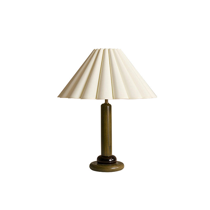 A Clérachic table lamp in a dark green wood stem and base, with a pleated cream shade, cut out on a white background.
