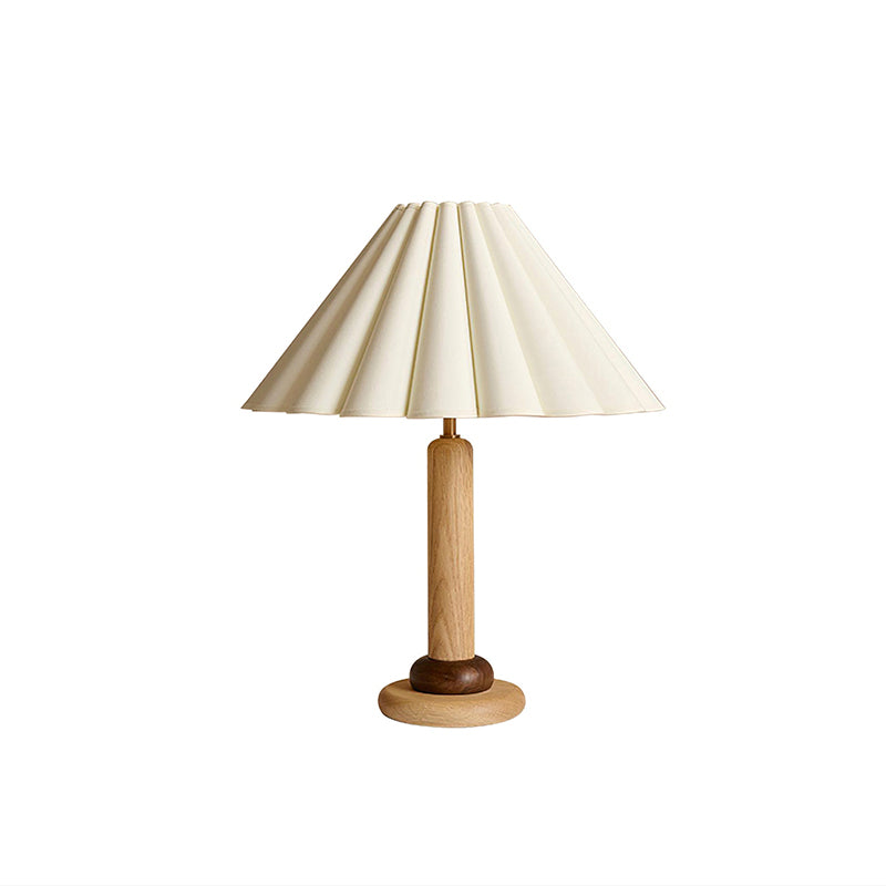 A Clérachic table lamp in natural light wood with a dark ring above the base and a pleated cream shade, on a white background.