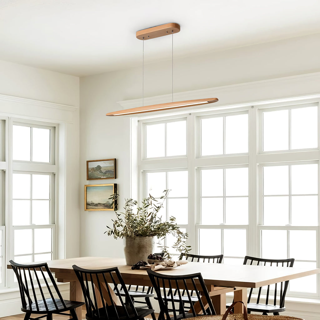Beech Clérachic pendant on its wooden canopy, seen in a white dining room with tall windows and black spindle chairs.
