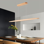 Close angle on a Clérachic beech pendant and its oval canopy, above a table with plates, candles and yellow flowers.