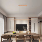 In a modern dining room with a wall-mounted television, a Clérachic beech pendant spans a long timber table.