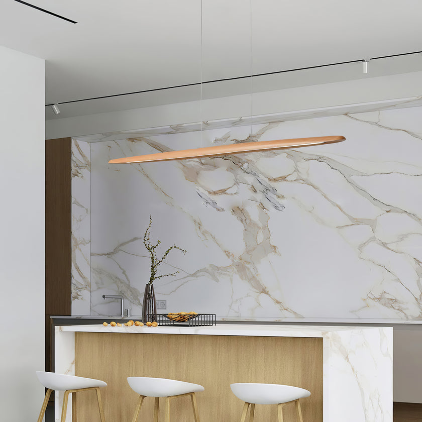 Clérachic beech pendant above a kitchen island with a stone worktop and white stools, in front of a marble splashback.