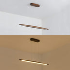 Two Clérachic pendants in dark walnut, one seen from the side and one lit from below, against a white ceiling and a warm wall.