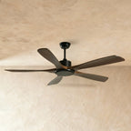Clérachic ceiling fan with five dark walnut-toned blades and a matt black motor, downrod and light disc, on a plaster ceiling.