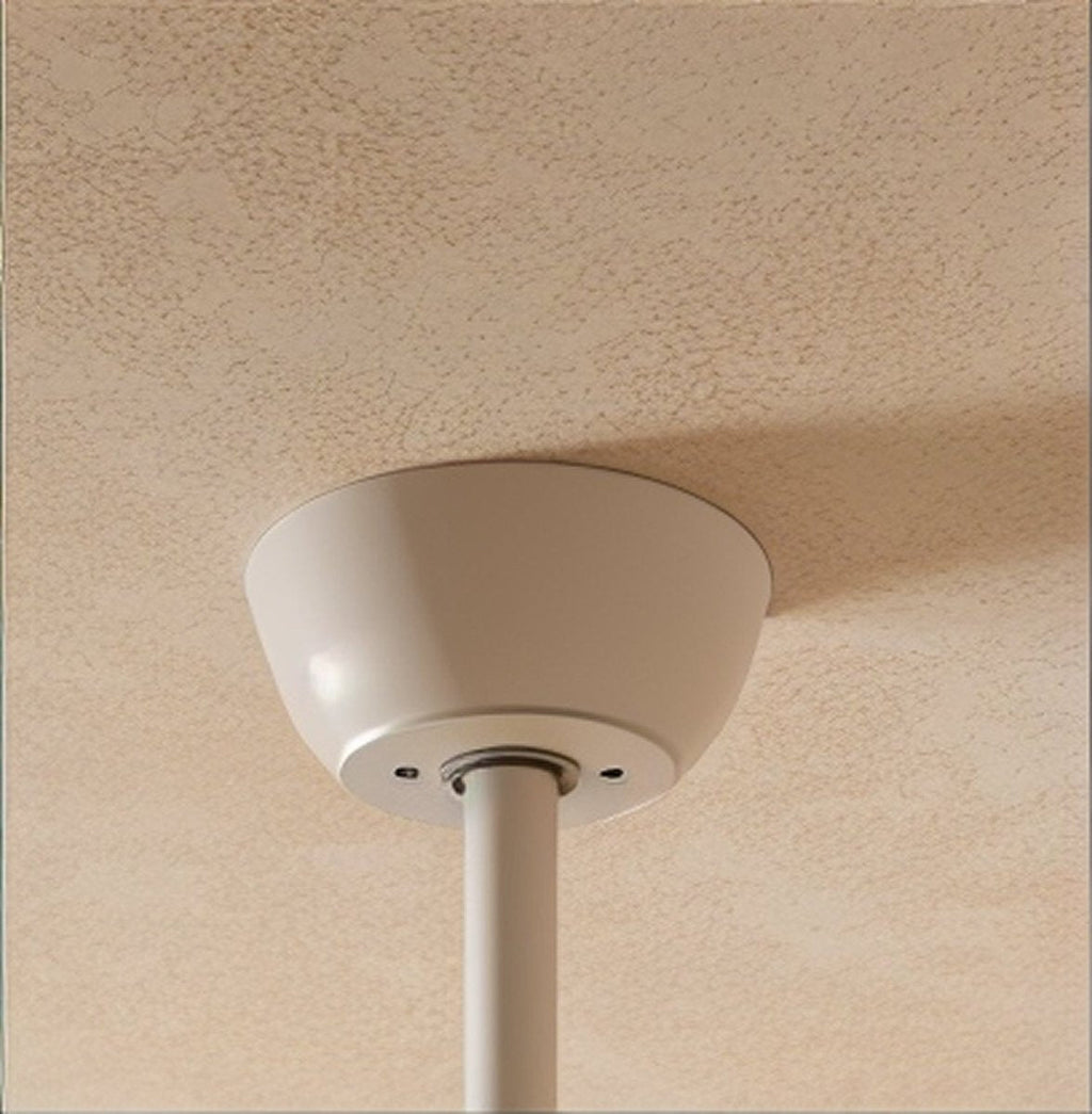 Clérachic fan's white ceiling canopy and slim white downrod fixed to a softly textured cream ceiling.