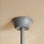 Clérachic fan's grey ceiling canopy and slim grey downrod fixed to a rough cream plaster ceiling.