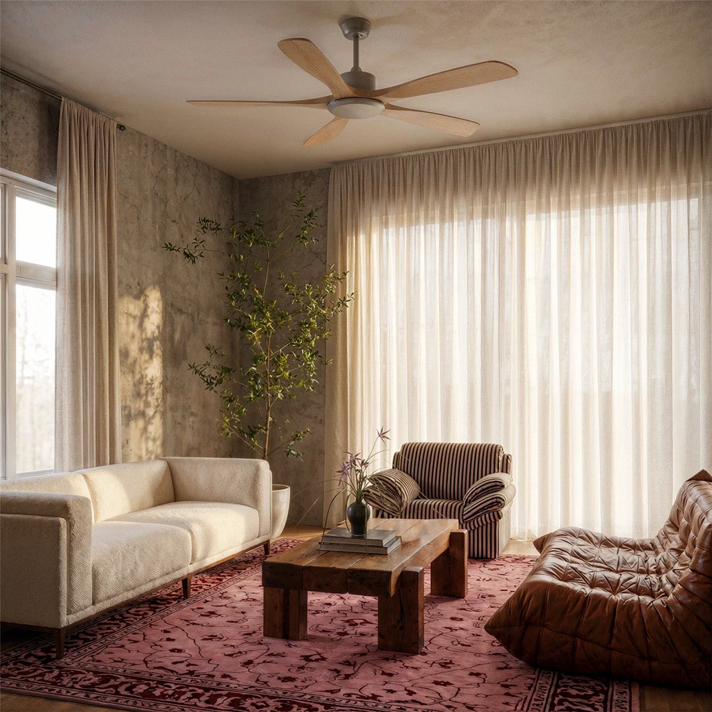 Clérachic five-blade ceiling fan with light wood blades hung in a living room with sheer curtains, a cream sofa and a leather lounger.