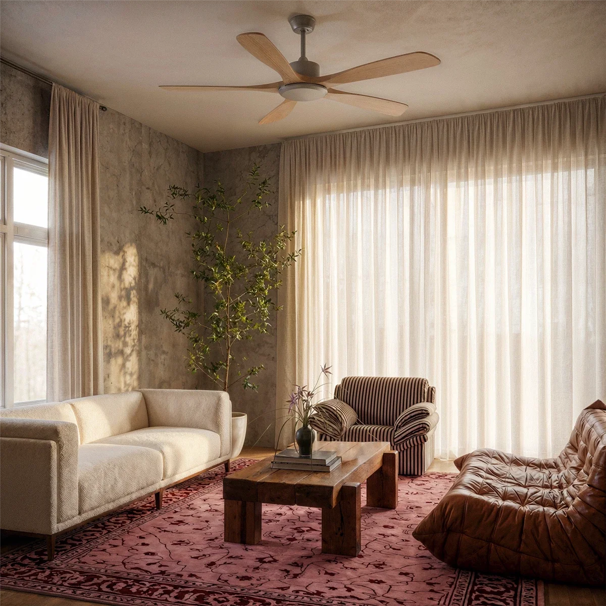 Clérachic five-blade ceiling fan with light wood blades hung in a living room with sheer curtains, a cream sofa and a leather lounger.
