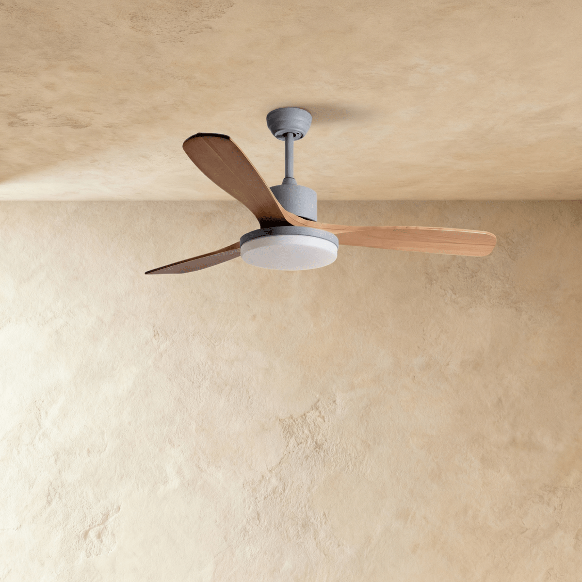 Clérachic ceiling fan on a grey downrod with three warm wood blades, the round LED light panel switched off.