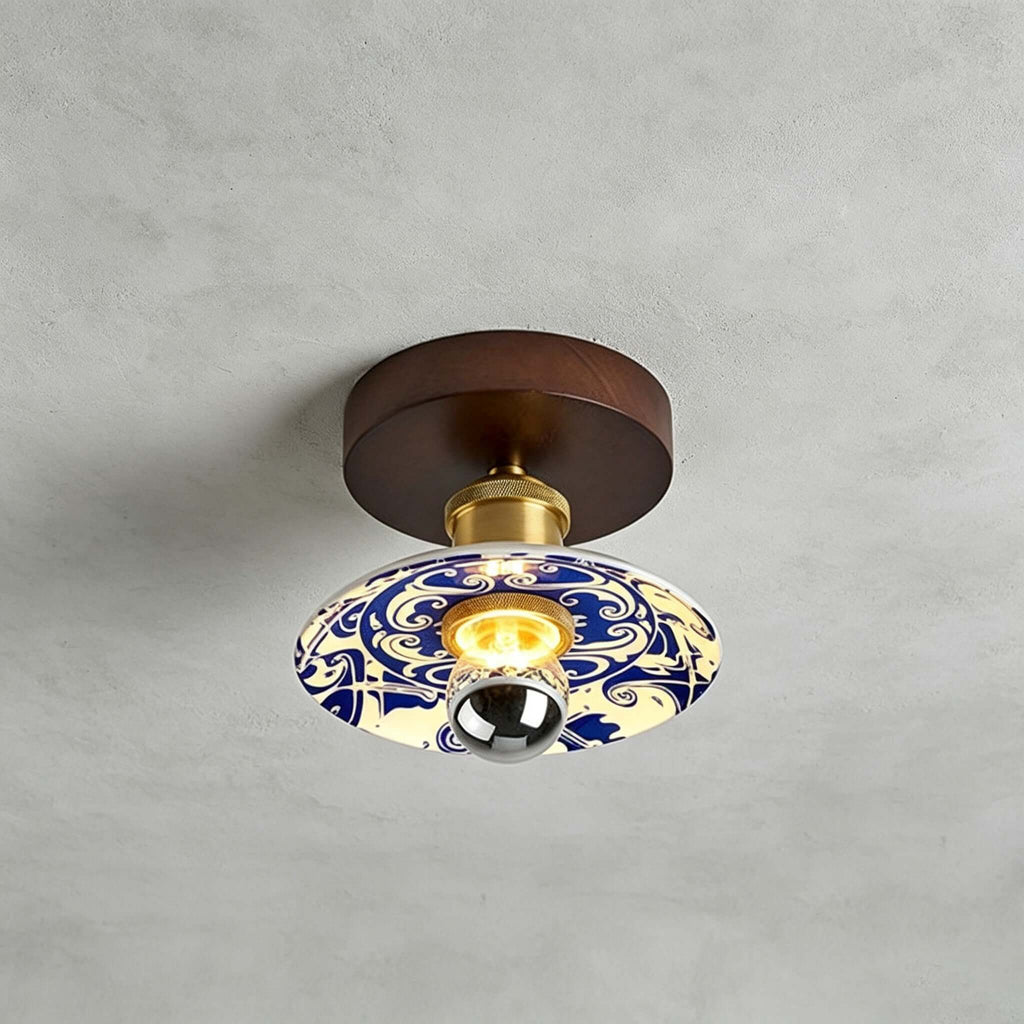 Close view of this Clérachic ceiling light on a grey concrete-look ceiling, with a swirling blue-and-white pattern on the shade.