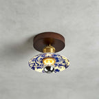 Close view of this Clérachic ceiling light on a grey concrete-look ceiling, with a swirling blue-and-white pattern on the shade.