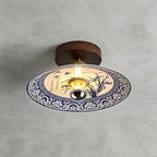 This Clérachic ceiling light shows an orchid painted in blue inside a border of blue-and-white scrollwork.