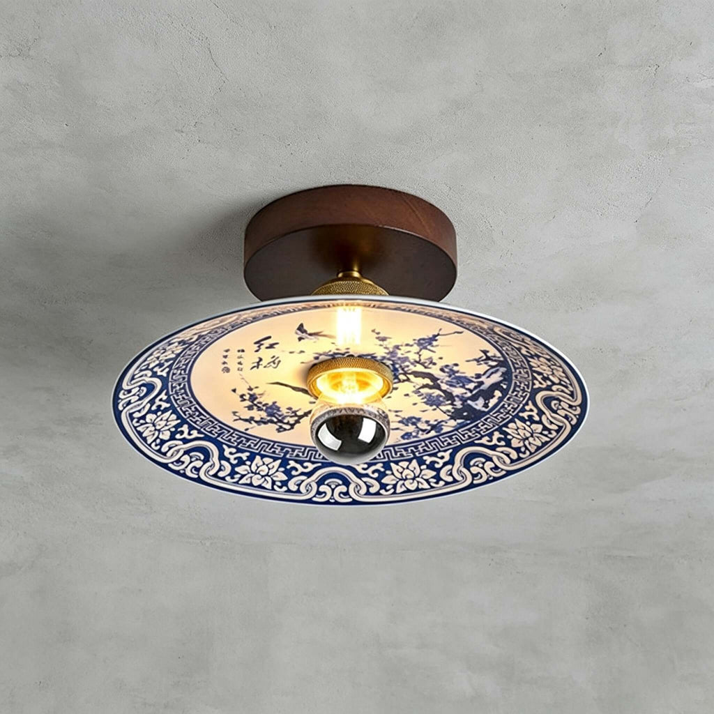 This Clérachic ceiling light shows plum blossom branches in blue on its shade, ringed by a blue lotus-scroll border.