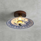 This Clérachic ceiling light shows plum blossom branches in blue on its shade, ringed by a blue lotus-scroll border.