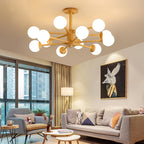 Light wood Clérachic ceiling light with lit white globes above a living room with a grey sofa, a floor lamp and a large framed print.