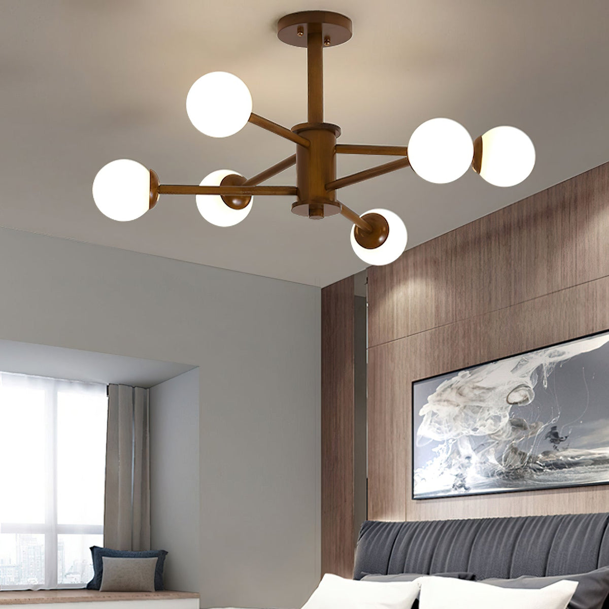 Close view of a walnut-toned Clérachic ceiling light with six white globes, with a bedroom and a framed abstract print below.